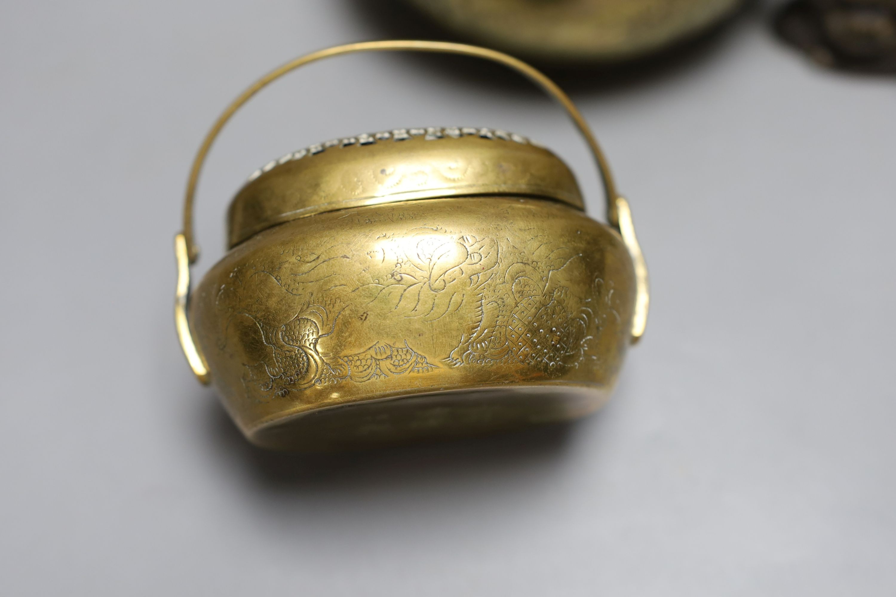 Two Chinese bronze hand warmers, one with Xuande mark, together with a seated Buddha, 16cm tall, (3)